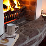 Fireside reading at Achill Cottages